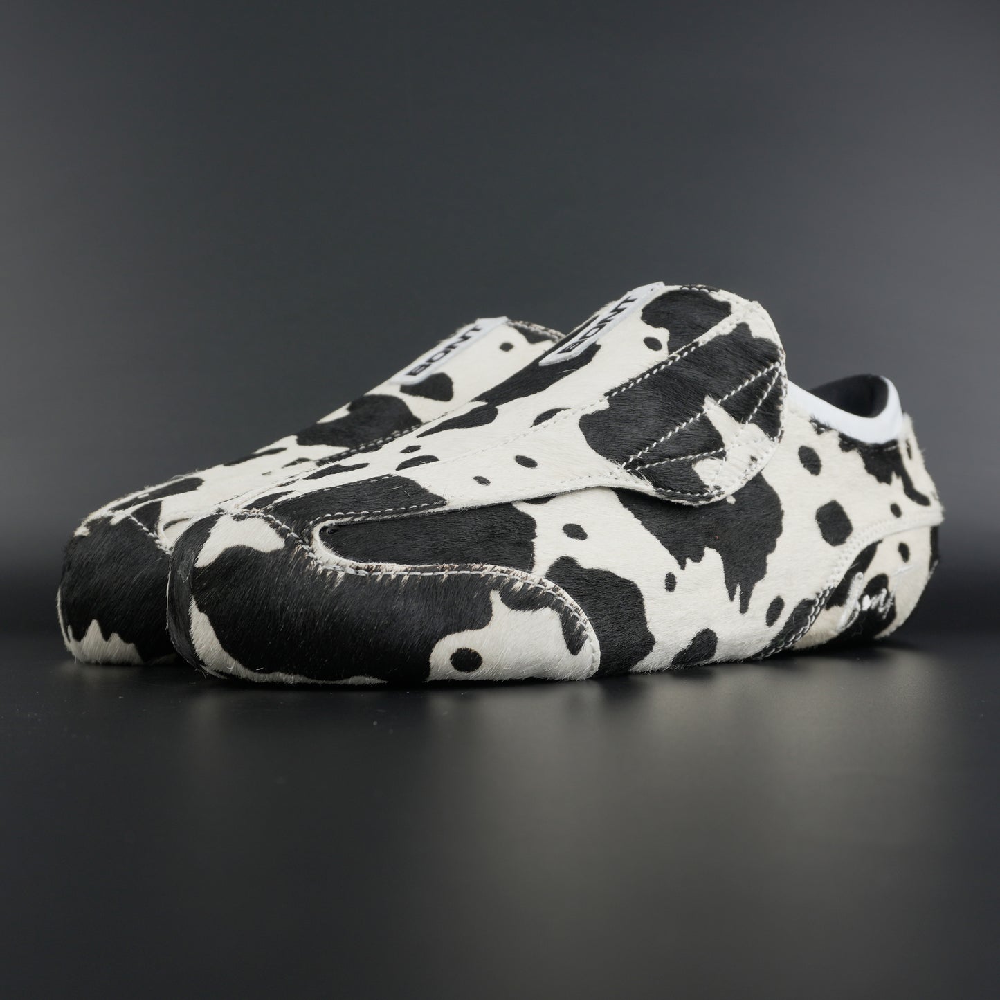 Angled view showing natural brown and white leather contrast