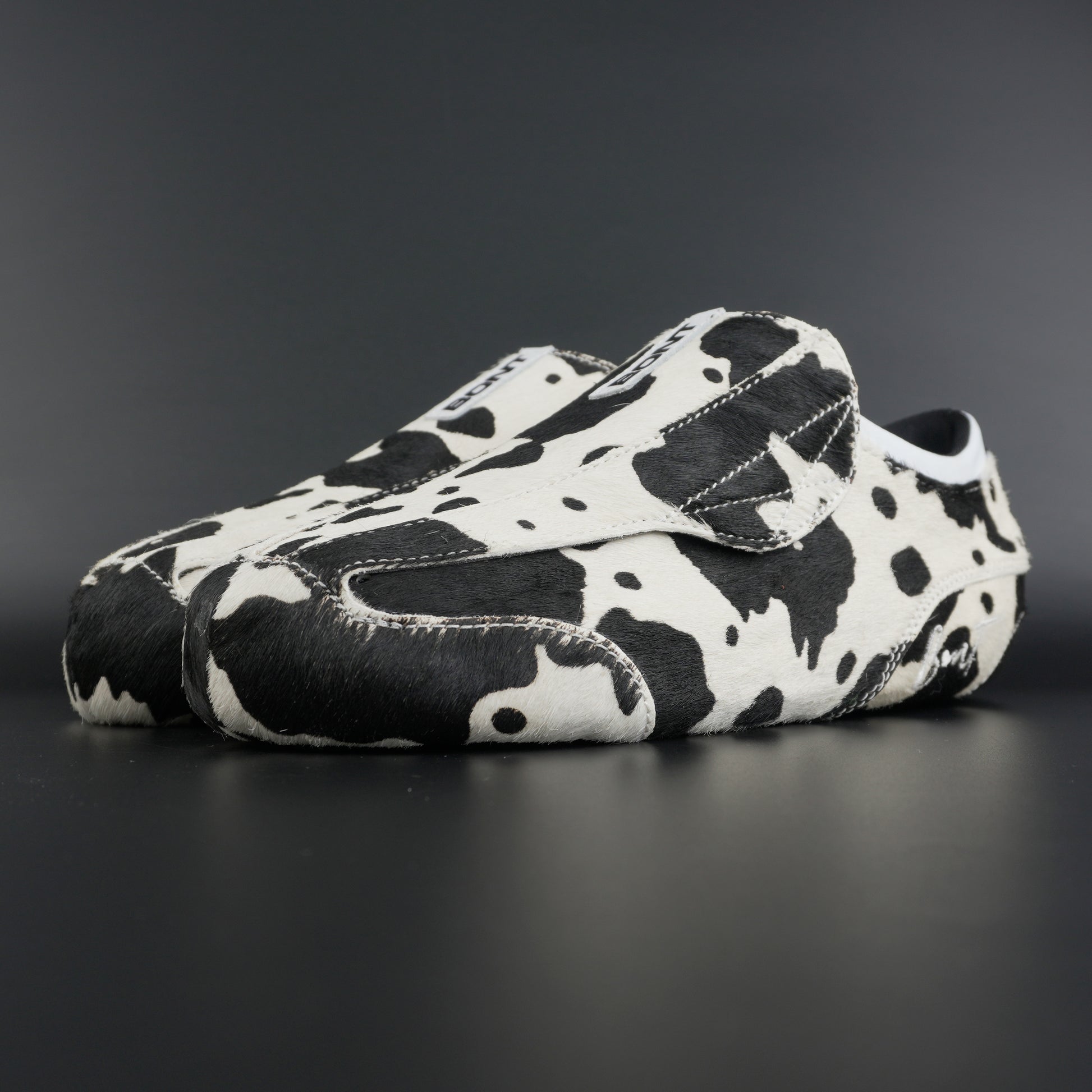 Angled view showing natural brown and white leather contrast