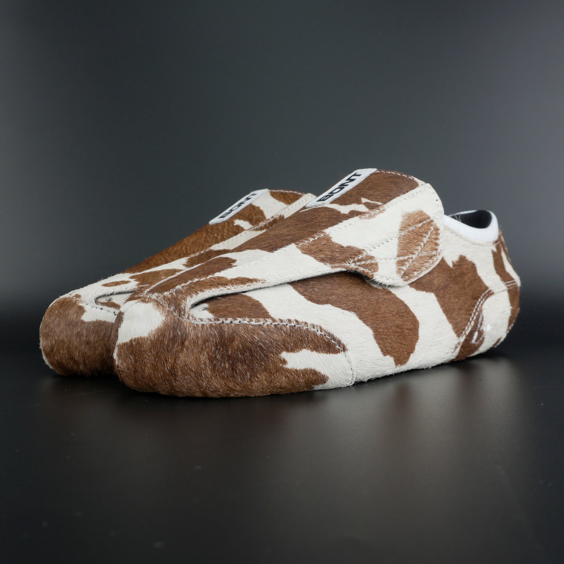 Angled view showing natural brown and white leather contrast