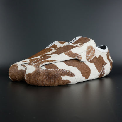 Angled view showing natural brown and white leather contrast