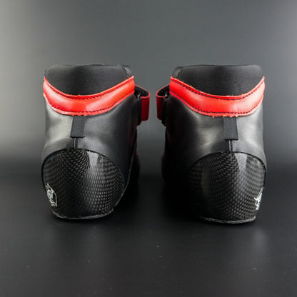 Close up showing the black boot with red trim and lacing details